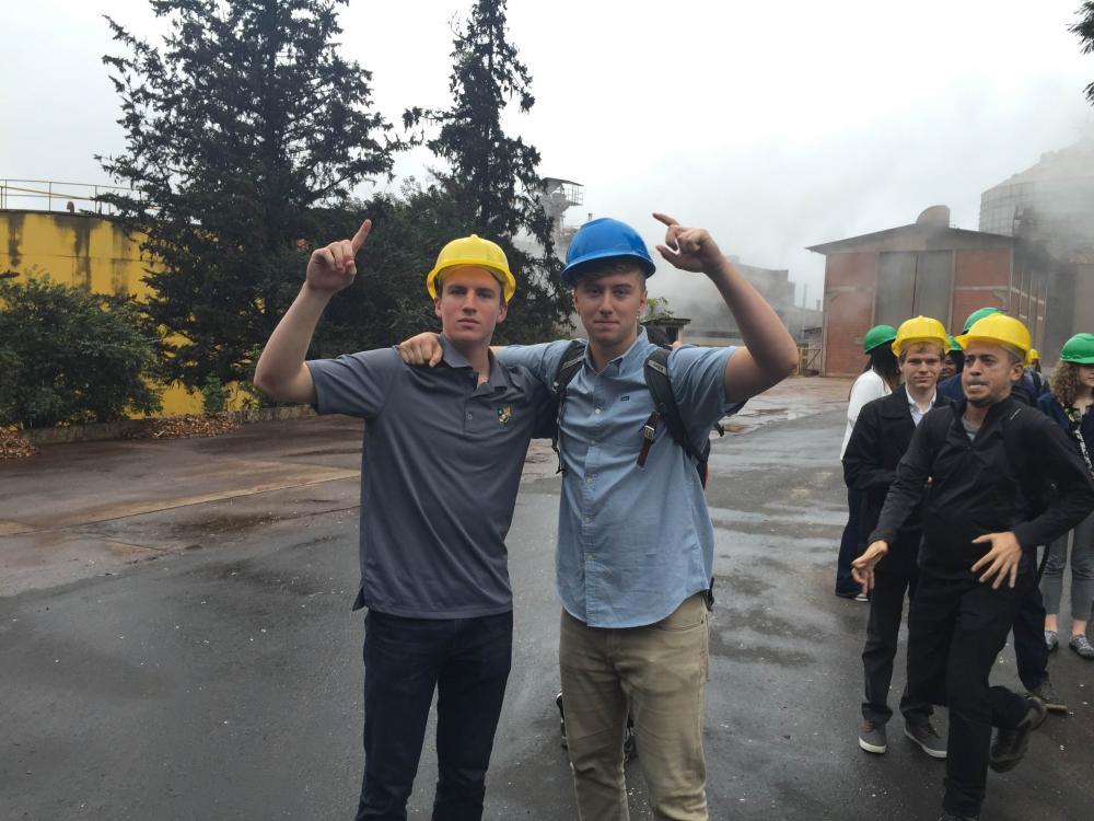 Two students wearing construction hats