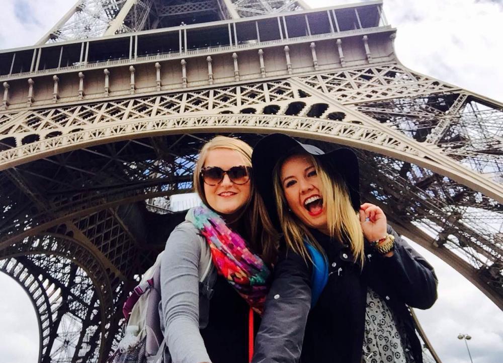 two ace students underneath the Eiffel Tower