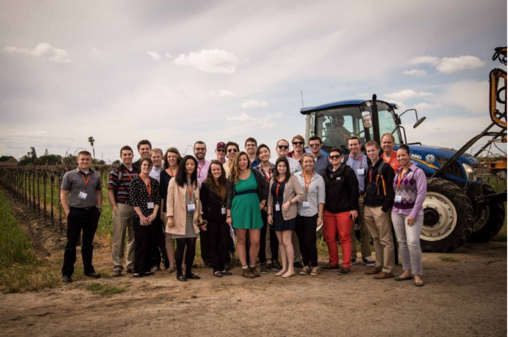 ACE students standing in front of a tractor