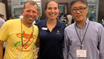 Three alums of ACE smiling together for a photo at an alumni gathering