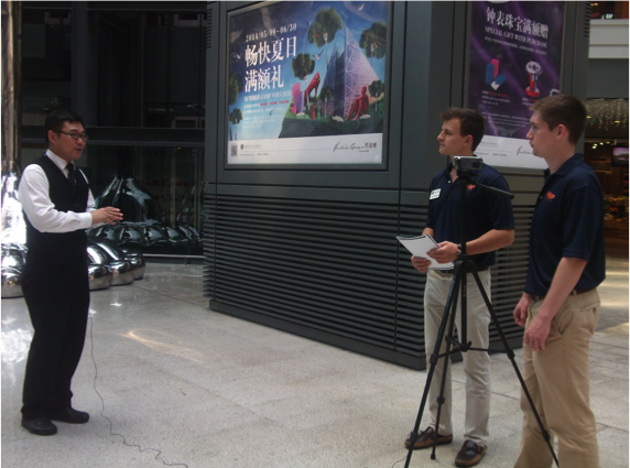 Two students interviewing someone on the street