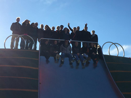 Students sitting on a large slide