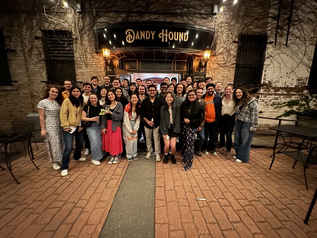 Graduate students pose in front of Restaurant 