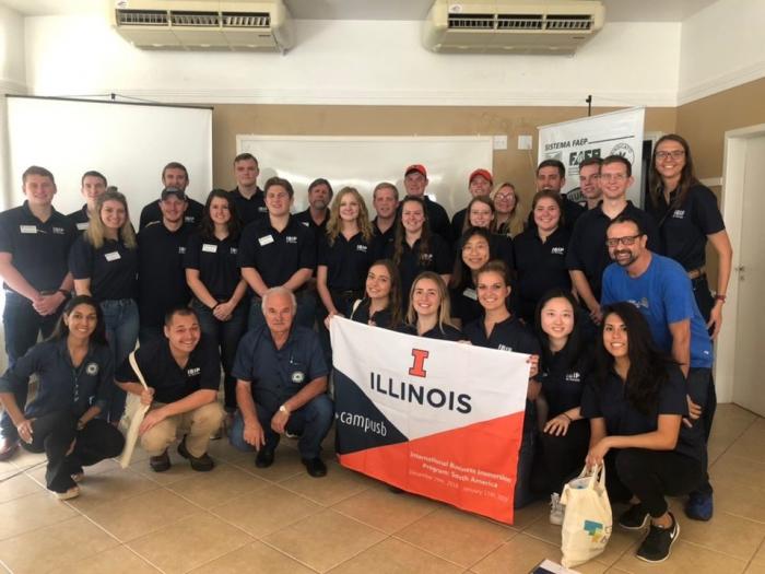 Students standing with a Illinois banner in a classroom