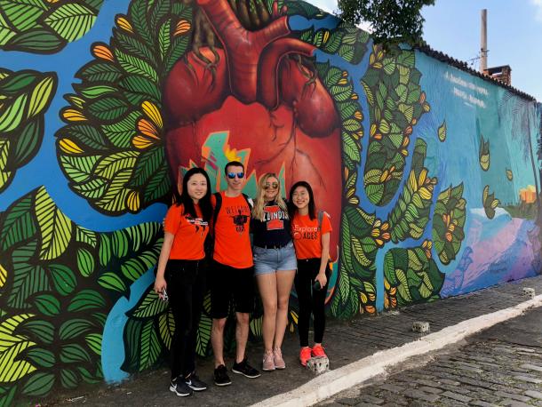 Students standing in front of graffiti heart