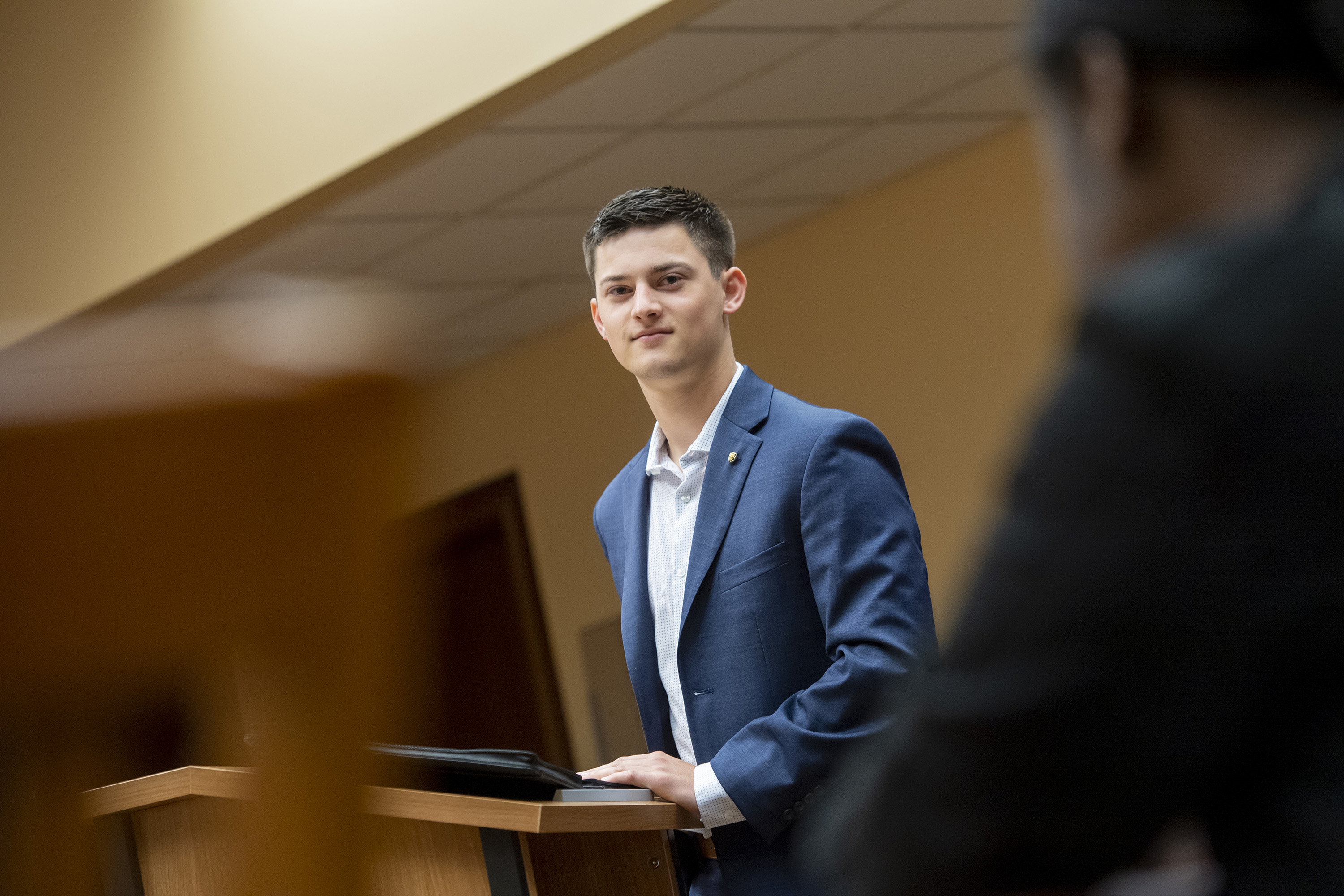 Student standing in front of classroom