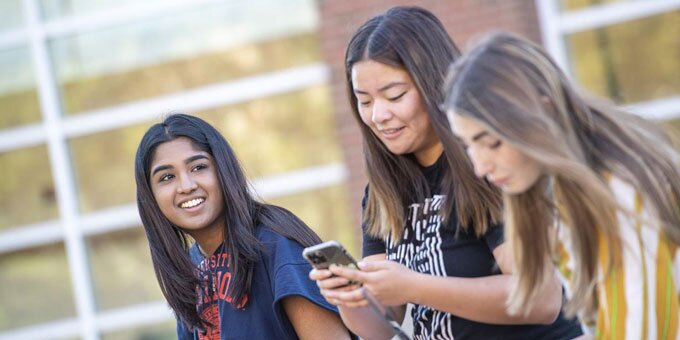 Three students sitting and talking