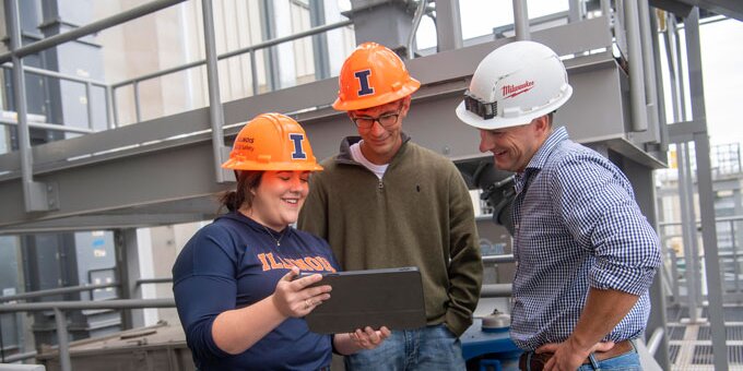 Students looking at data with hard hats on