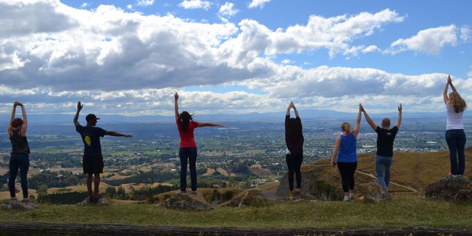 Study abroad students forming ILLINI looking over a city