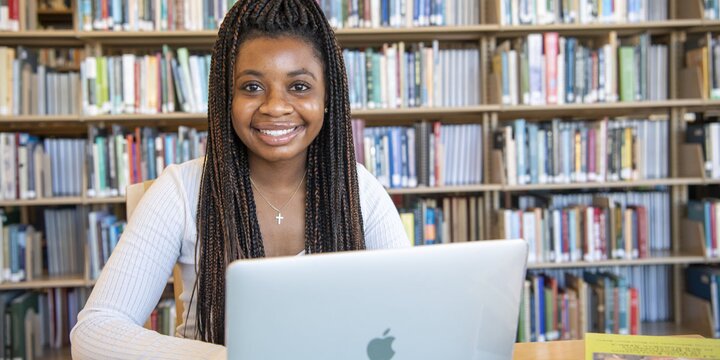 Student sitting at a desk working on a computer