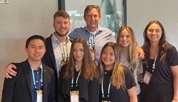 Students and faculty posing at conference