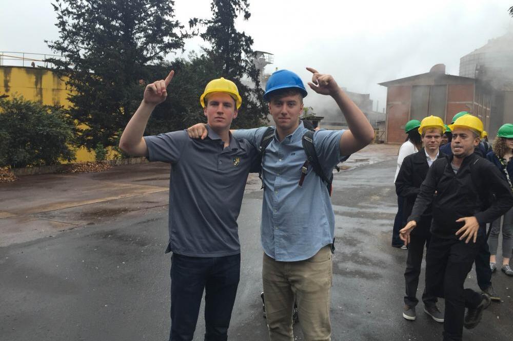 Two students wearing construction hats