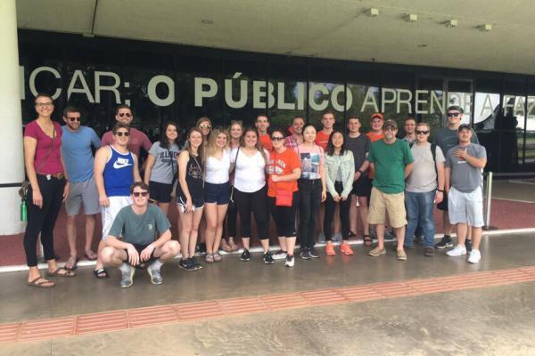 Study abroad students in front of a sign