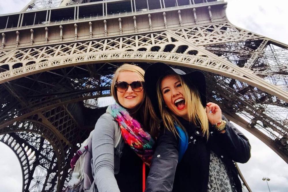 two ace students underneath the Eiffel Tower