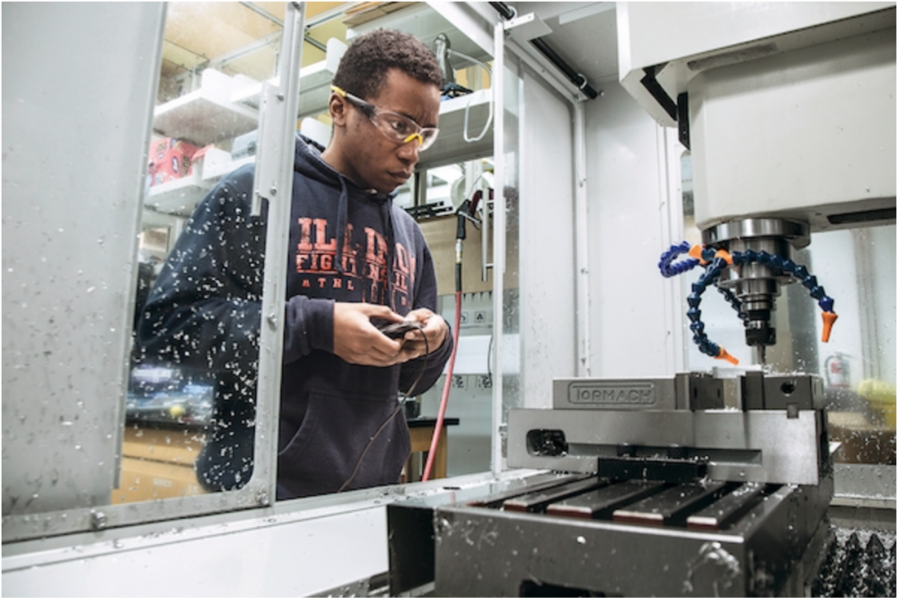 Andrew Knight, a student in TSM, working on a machine