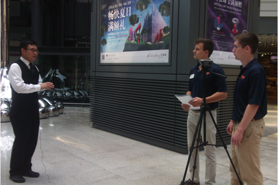 Two students interviewing someone on the street